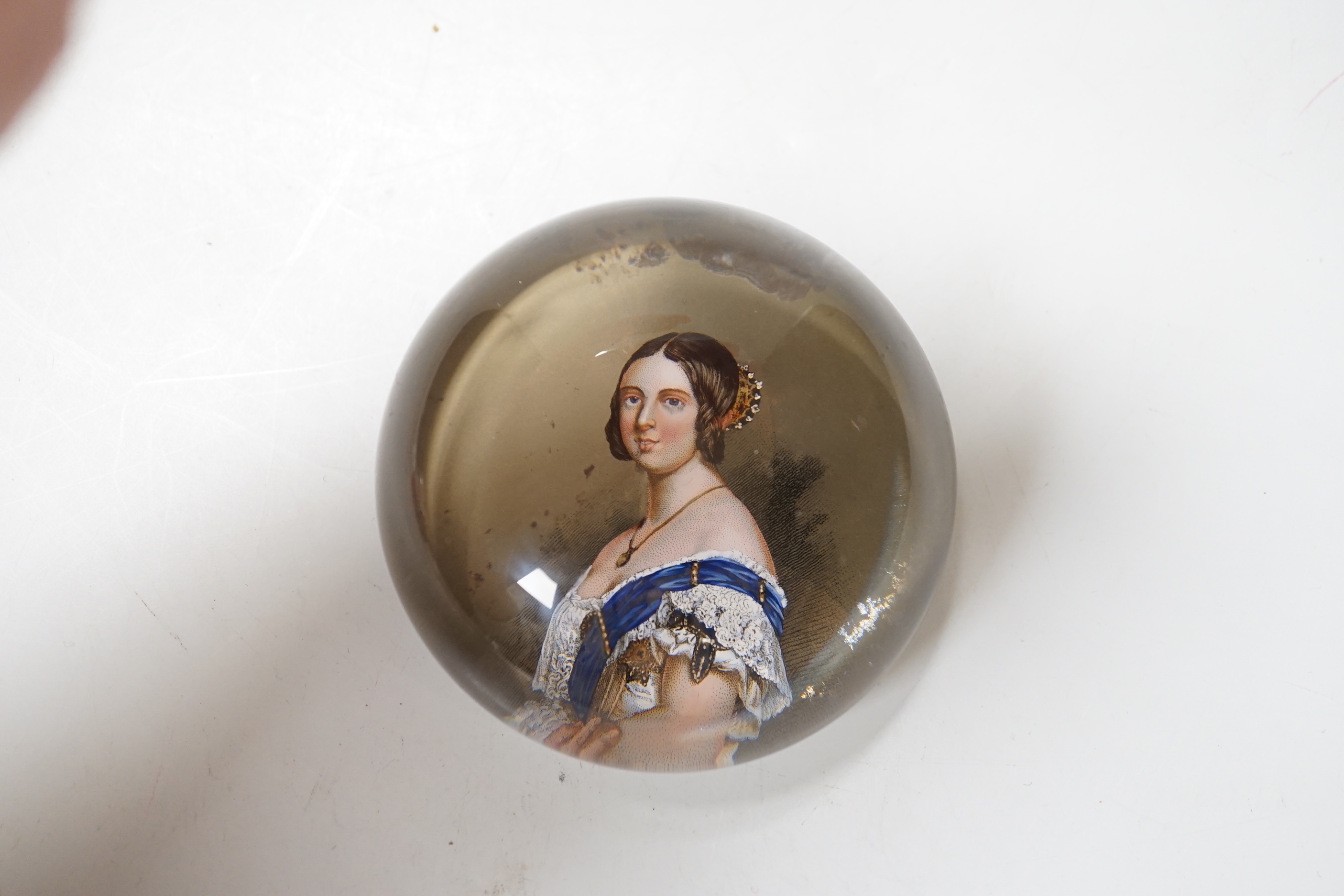 A Queen Victoria reverse decorated glass paperweight, approximately 7.5cm diameter